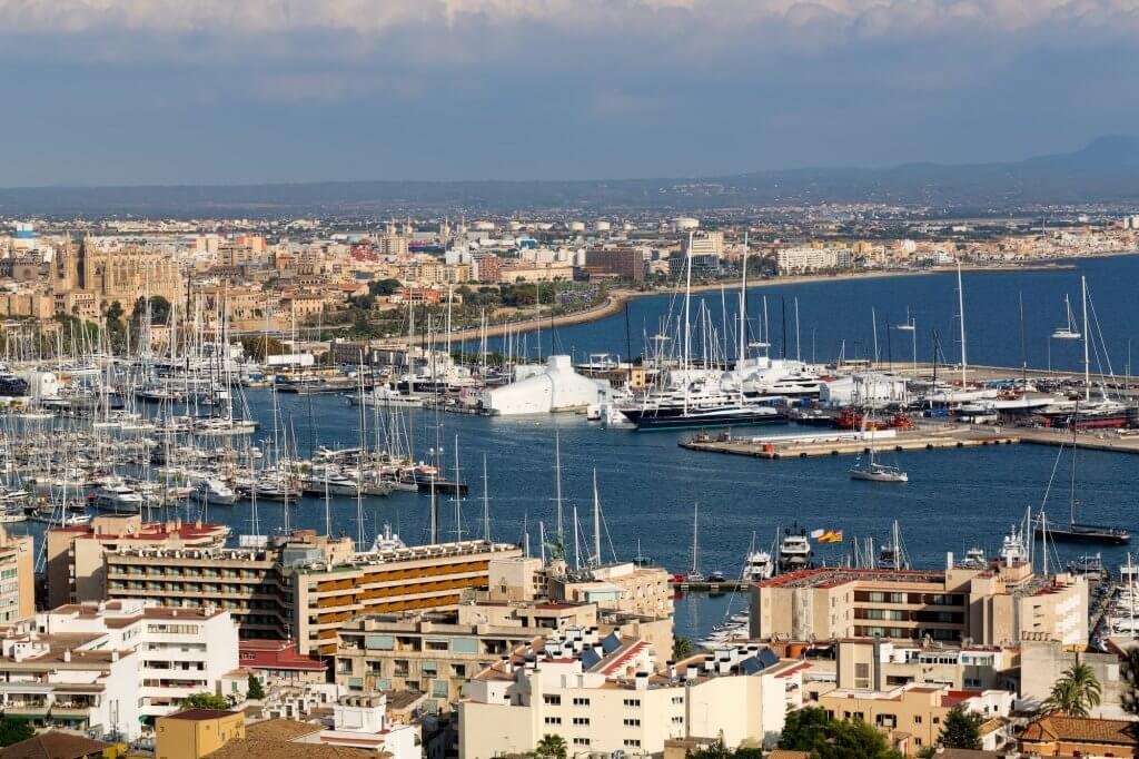 port with yachts and the city of Palma De Mallorca