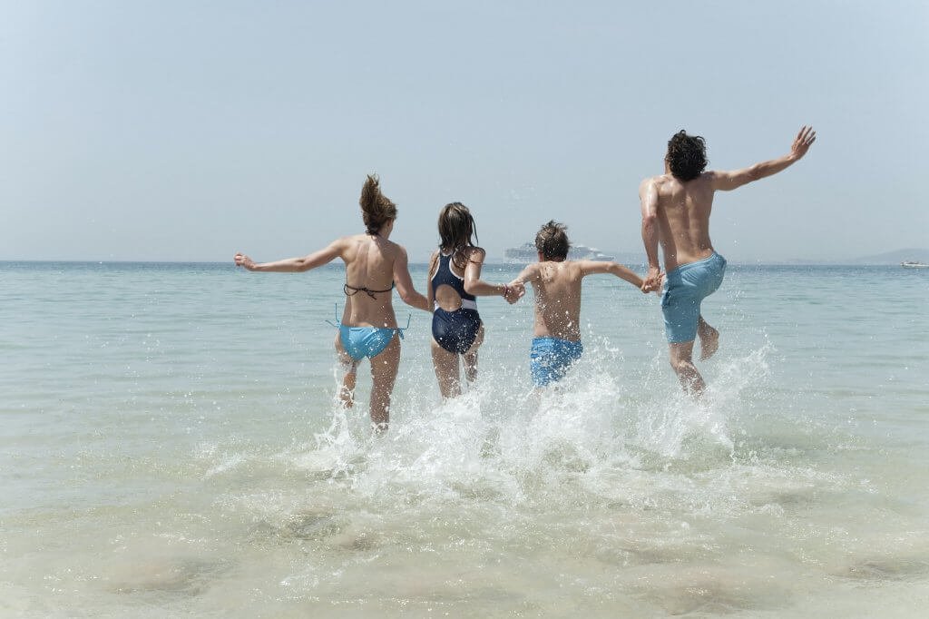 Spain, Mallorca, Family jumping into sea